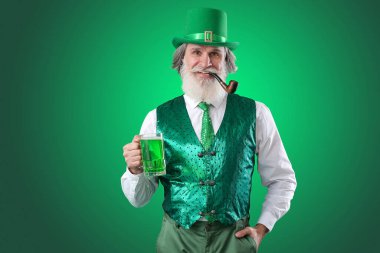 Yeşil arka planda sigara piposu ve bir bardak bira olan son sınıf öğrencisi. Aziz Patrick Günü kutlaması