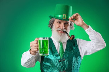 Yeşil arka planda sigara piposu ve bir bardak bira olan son sınıf öğrencisi. Aziz Patrick Günü kutlaması