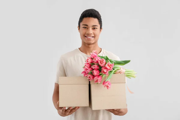 African American Man Gift Boxes Bouquet Tulips Light Background International — Stock Photo, Image