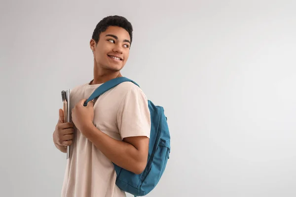 Male African American Student Notebooks Backpack Looking Aside Light Background — Stock Photo, Image