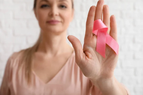 Female Palm Pink Awareness Ribbon White Brick Wall Background Closeup — Stock Photo, Image