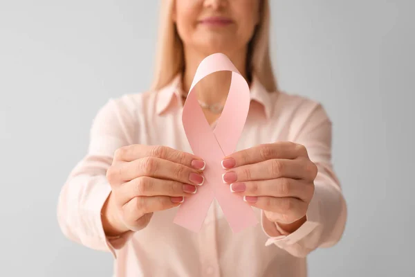 Woman Holding Pink Awareness Ribbon Light Background Closeup Breast Cancer — Stock Photo, Image