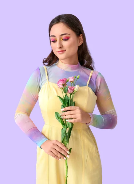 Kvinna Med Kreativ Makeup Tittar Ner Och Hålla Eustoma Blommor — Stockfoto