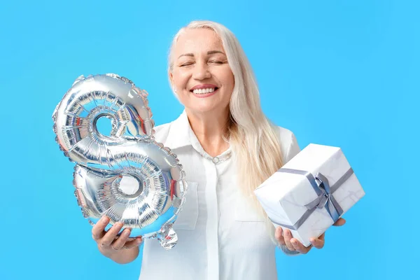 Happy Mature Woman Closed Eyes Holding Balloon Gift Box Blue — Stock Photo, Image