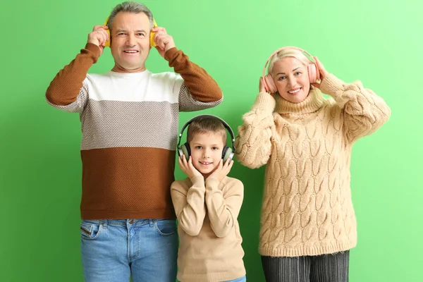 Liten Pojke Med Sina Morföräldrar Varma Tröjor Lyssnar Musik Grön — Stockfoto