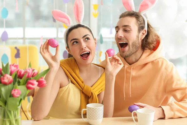 Happy Couple Bunny Ears Easter Eggs Sitting Table — Stock Photo, Image