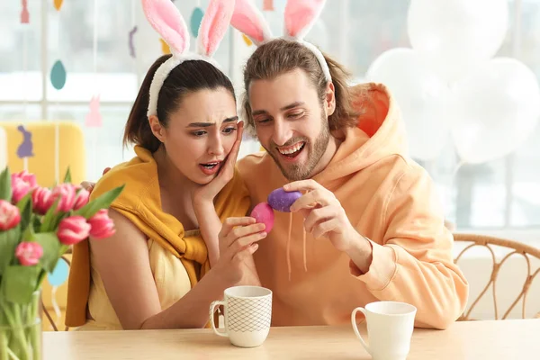 Young Couple Bunny Ears Breaking Easter Eggs Table — Stock Photo, Image
