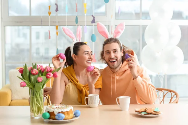 Happy Couple Bunny Ears Easter Eggs Sitting Table — Stock Photo, Image