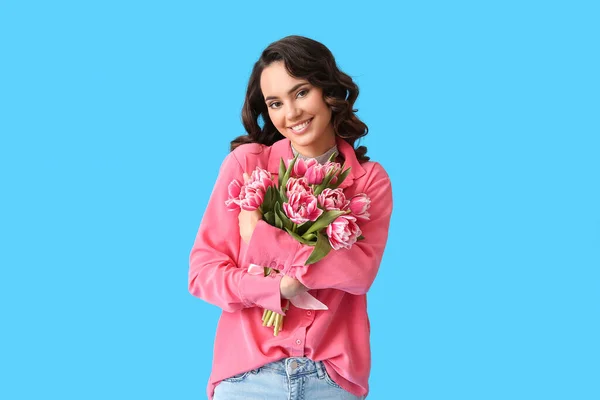 Lächelnde Junge Frau Mit Einem Strauß Tulpen Auf Blauem Hintergrund — Stockfoto