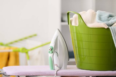 Çamaşır sepeti ve elektrikli ütü.