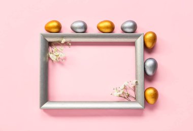 Çerçeveli güzel kompozisyon, pembe arka planda Paskalya yumurtaları ve çiçekler