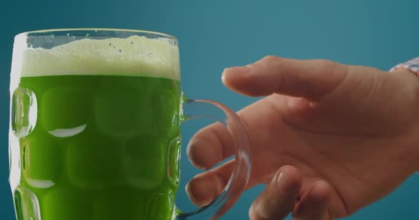 Man Drinking Green Beer Blue Background Closeup Patrick Day Celebration — Stock Video