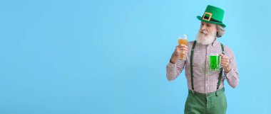 Mavi arka planda bira bardakları ve mesaj için yeri olan son sınıf öğrencisi. Aziz Patrick Günü kutlaması