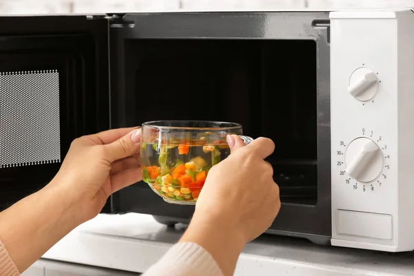 Woman Putting Glass Bowl Broth Microwave Oven Closeup — Stock Photo, Image