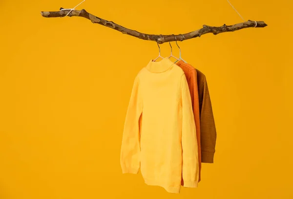 Different Knitted Sweaters Orange Background — Stock Photo, Image