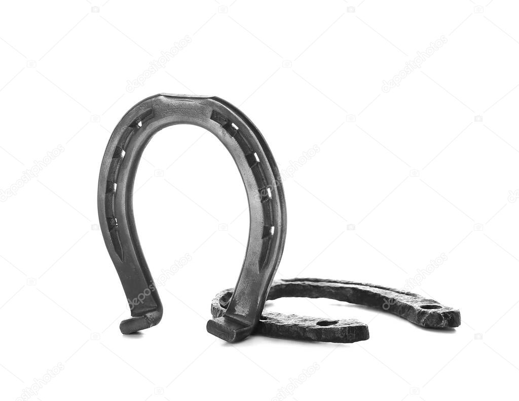 Iron horseshoes on white background