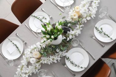 Yemek masasında güzel bir ortam, çiçekler ve boş kartlar.