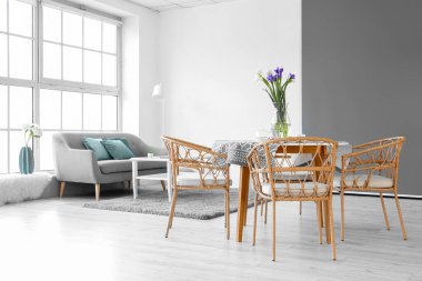 Odadaki yemek masasında güzel süsen çiçekleri olan vazo.