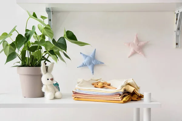 Stack Baby Clothes Toys Houseplant Self Light Wall — Stock Photo, Image