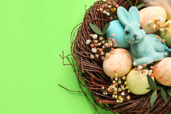Yeşil Arka Planda Boyanmış Paskalya Yumurtaları Tavşanı Çiçekleri Olan Yuva — Stok fotoğraf