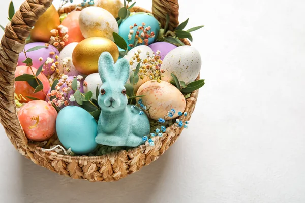 装有彩绘复活节彩蛋 兔子和浅色背景的花朵 — 图库照片