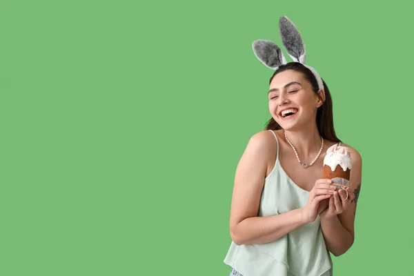 Young Woman Bunny Ears Tasty Easter Cake Green Background — Stock Photo, Image