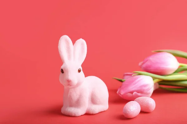 可爱的复活节兔子 有彩绘的蛋和红色背景的花 — 图库照片