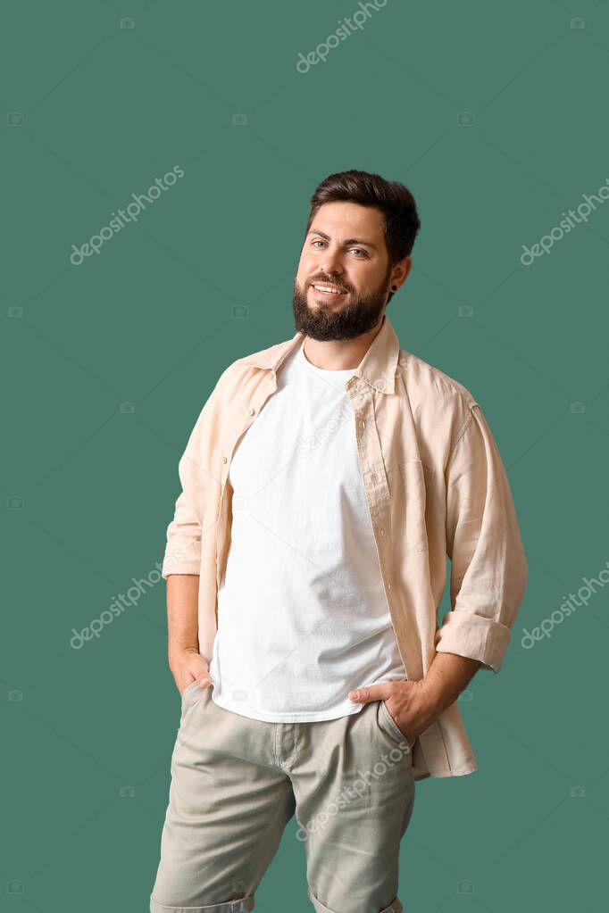 Handsome man in white t-shirt on green background