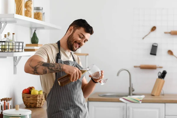 Young Bearded Man Pouring Beer Glass Kitchen — Stock Photo, Image