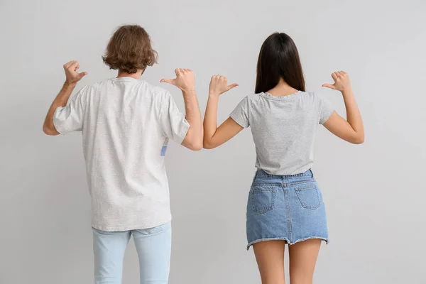 Young Couple Stylish Shirts Light Background Back View — Stock Photo, Image