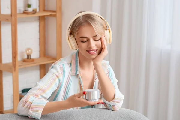 Woman Headphones Looking Wireless Portable Speaker Room — Stock Photo, Image