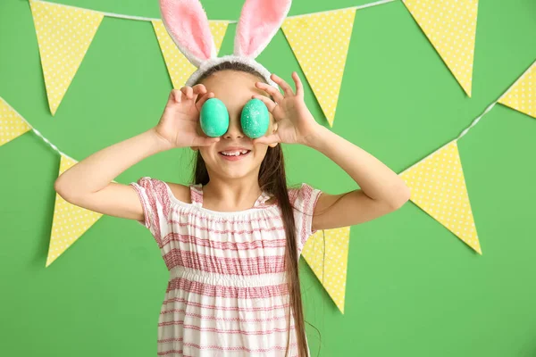 Little Girl Bunny Ears Closing Eyes Easter Eggs Green Background — Stock Photo, Image