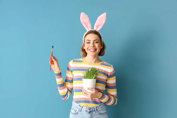Beautiful Young Woman Bunny Ears Brush Houseplant Blue Background Easter — Stock Photo, Image