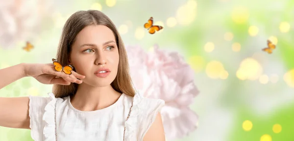 stock image Beautiful young woman with butterflies on blurred background