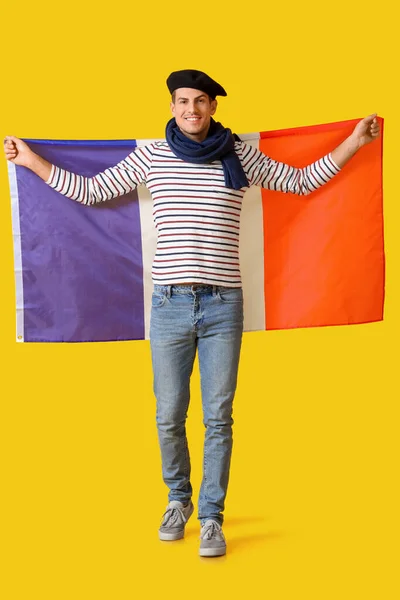 Joven Guapo Con Bandera Francia Sobre Fondo Amarillo —  Fotos de Stock