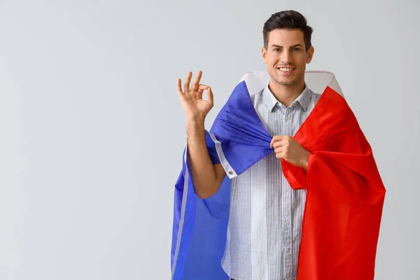 Joven Guapo Con Bandera Francia Mostrando Sobre Fondo Claro —  Fotos de Stock