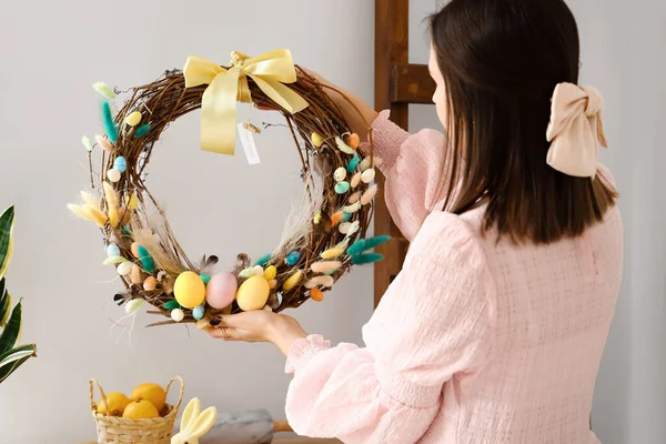 Woman Holding Beautiful Easter Wreath Light Wall — Stock Photo, Image