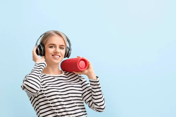 Woman Headphones Holding Modern Wireless Portable Speaker Blue Background — Stock Photo, Image