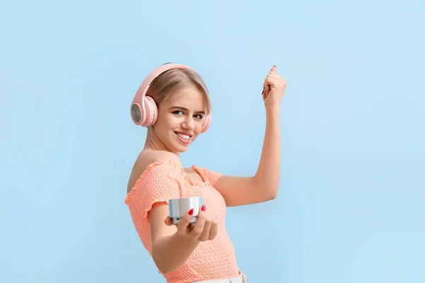 Young Woman Headphones Wireless Portable Speaker Dancing Blue Background — Stock Photo, Image
