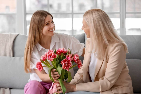 Young Woman Greeting Her Mother Bouquet Tulips Home Holiday — Stock Photo, Image