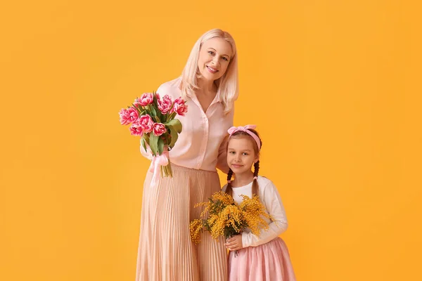Klein Meisje Met Haar Oma Bloemen Gele Achtergrond Internationale Vrouwendag — Stockfoto