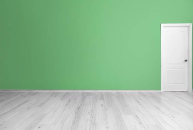 Büyük boş odada kapısı olan yeşil duvar manzarası