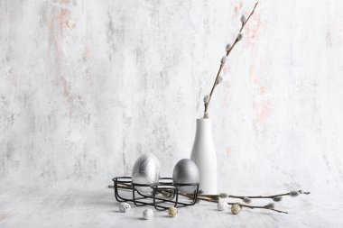 Composition with Easter eggs and pussy willow branches on  light background