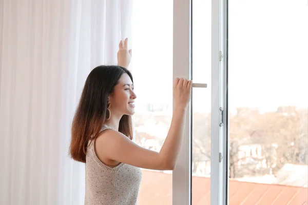 Pretty Young Asian Woman Opening Window Home — Stock Photo, Image