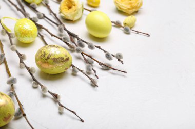 Hafif arka planda söğüt dalları ve boyanmış Paskalya yumurtaları