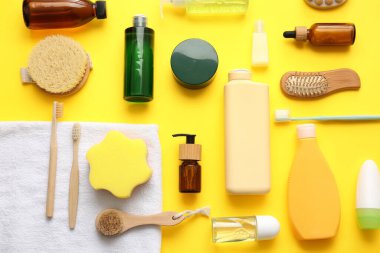 Sarı arka planda farklı banyo malzemelerine sahip kompozisyon