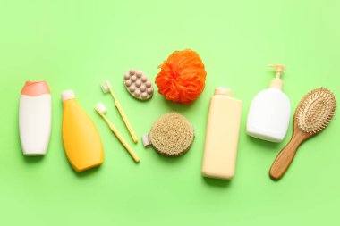 Yeşil arka planda kozmetik ürünleri ve banyo aksesuarlarıyla kompozisyon
