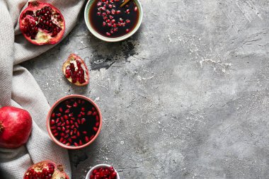 Gri arkaplanda bir kase nar pekmezi.