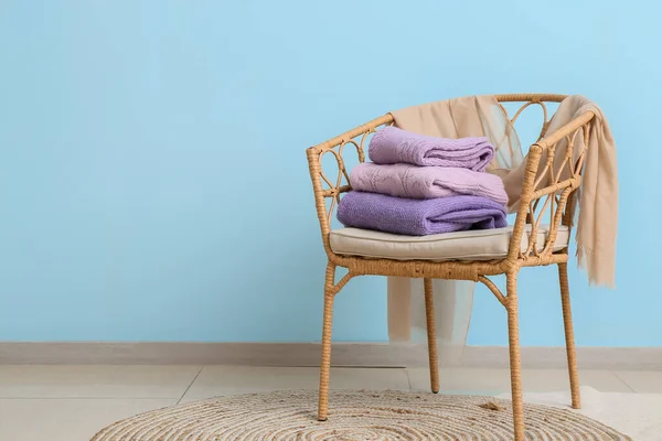 Wicker Armchair Stack Lilac Sweaters Blue Wall — Stock Photo, Image