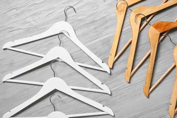 Different Clothes Hangers Wooden Background — Stock Photo, Image